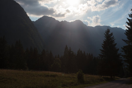 Crepuscular rays, commonly known as sunbeams, sun rays, or god rays over the Julian Alps in Sloveniaの写真素材