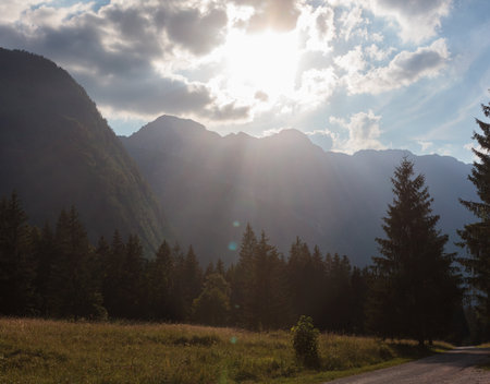 Crepuscular rays, commonly known as sunbeams, sun rays, or god rays over the Julian Alps in Sloveniaの写真素材