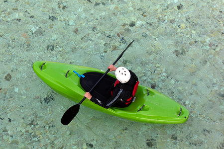 River Kayaker Aerial View. Caucasian Sportsman in the green Kayak Paddling on the Scenic Soca river, Bovec, Sloveniaの写真素材