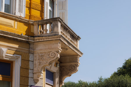 Ancient balcony decorated with ornamental stone elements on a historic building facade in the center of Pula, Croatia, reflecting traditional Mediterranean architectureの写真素材