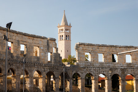View of Catholic Church next to the Roman Amphitheater, Pula, Istria County, Croatia, Adriatic, Europeの写真素材