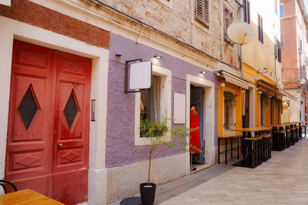 View of the sunny colorful stone street of ancient Pula town, Croatiaの写真素材