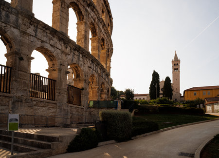 Ancient heritage in Pula, Istria, Croatia. Arches of monumental ancient Roman arena. Detail of historic amphitheater, wide angle view of high walls on blue sky background.の写真素材