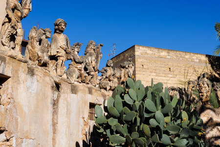 View of people and monster sculptures made of tuff in the Villa Palagonia, which earned the nickname "The Villa of Monsters," 18th century, Bagheria, Sicily, Italyの写真素材