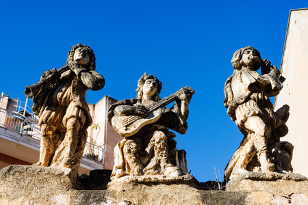 View of people and monster sculptures made of tuff in the Villa Palagonia, which earned the nickname "The Villa of Monsters," 18th century, Bagheria, Sicily, Italyの写真素材