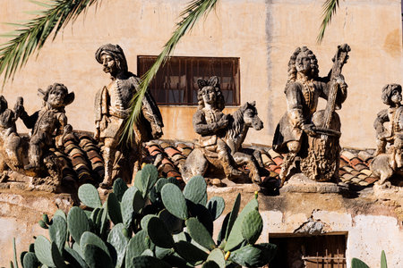 View of people and monster sculptures made of tuff in the Villa Palagonia, which earned the nickname "The Villa of Monsters," 18th century, Bagheria, Sicily, Italyの写真素材
