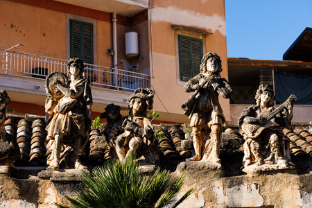 View of people and monster sculptures made of tuff in the Villa Palagonia, which earned the nickname "The Villa of Monsters," 18th century, Bagheria, Sicily, Italyの写真素材