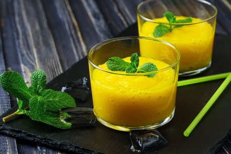 Homemade mango and pineapple smoothie made with coonut milk.の写真素材