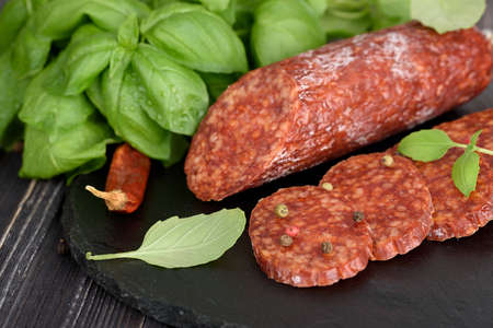 Delicious salami with fresh basil, chili. selective focusの写真素材