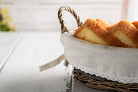 Toast bread in basket on white wooden table