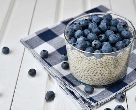 Chia pudding with berries and milk, sweet nourishing dessert, healthy breakfast superfood conceptの写真素材