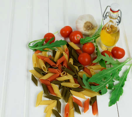Italian food cooking pasta ingredients. Food ingredients for Italian pasta on white wooden background with much copy space of your project.の写真素材