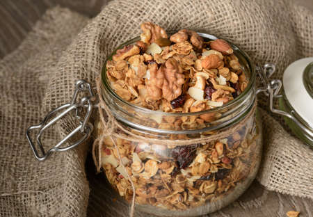 Granola from several types of cereals with nuts,coconut chips and dried cranberry.の写真素材