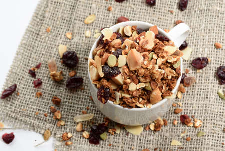 Homemade granola in a glass jar on white backgroundの写真素材