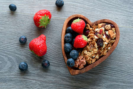 Homemade  granola with  fresh berry in wooden bowlの写真素材