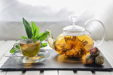 Exotic green tea with flowers in glass teapotの写真素材