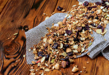 Background with dry muesli on old wooden deskの写真素材