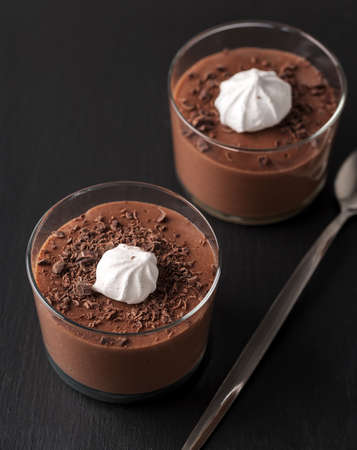 Chocolate mousse in a glasses on a black stone background.の写真素材