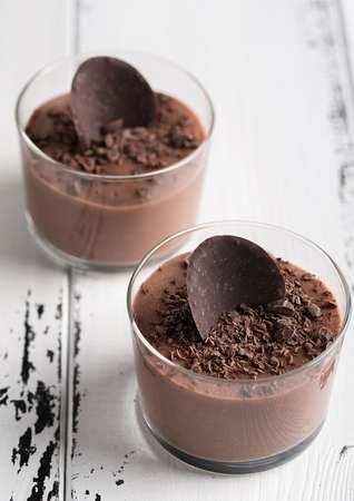Chocolate mousse in a glasses on a white wooden background.の写真素材