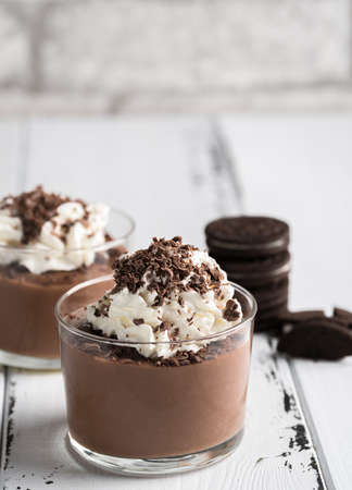 Chocolate mousse in a glasses on a white wooden background.の写真素材