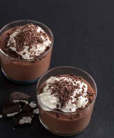 Chocolate mousse in a glasses on a black stone background.の写真素材