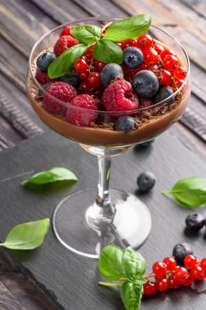 Ideas for a healthy diet. Dietary Chocolate mousse, parfait with fresh berries of raspberries, blueberries and red currants in a glass gobletの写真素材