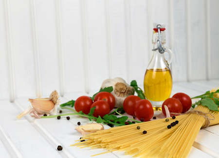 Food ingredients for Italian spaghetti on white wooden background with much copy space of your project.の写真素材