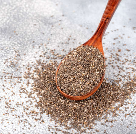 Healthy Chia seeds in a wooden spoon on the table close-upの写真素材