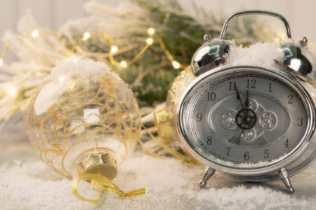 Christmas card with clock and christmas ornament, selective focus and square image.