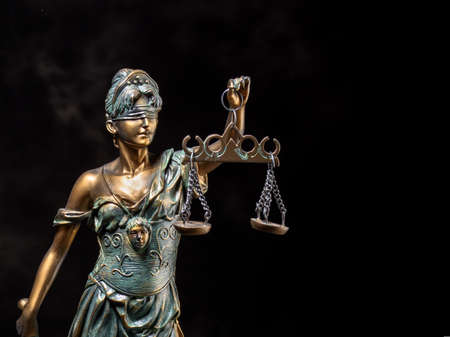 Photography of bronze themis sculpture, femida or justice goddess on dark background.の写真素材
