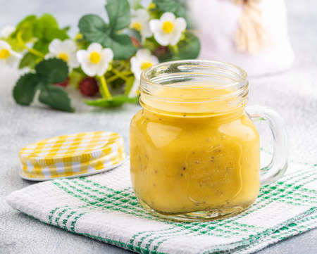 Smoothie with tropical fruits: mango, banana, avocado, chia seeds in a glass jar.の写真素材