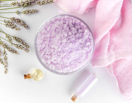 Lavender spa setting: salt, essential oil and dried flowers natural spa products and decor for bath on light background.の写真素材
