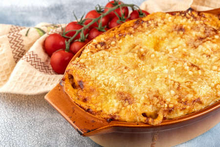 Traditional italian cannelloni with vegetables, minced meat and cheese. On a wooden background. Top view, copy space.の写真素材