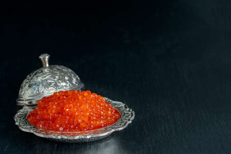 Red caviar in silver bowl on black background.の写真素材