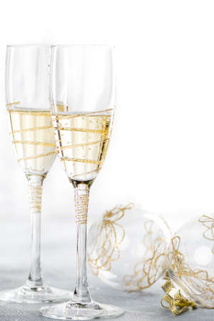 Greeting card: Christmas and New Year concept.  glasses of champagne with Christmas balls on a white background.の写真素材