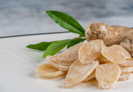 Sweet and Spicy Candied Ginger in a Bowl on light background. Copy spaceの写真素材