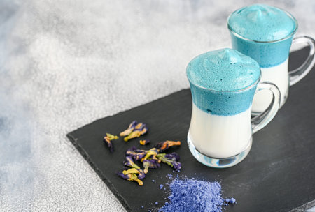 Dalgona Matcha Blue Latte, a creamy whipped matcha in glass on light background.の写真素材