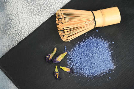 Blue matcha tea powder on a dark background. Eastern strengthening tea for health and weight loss.の写真素材