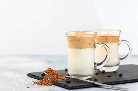 Two glass cups with Dalgona frothy coffee trend korean drink latte espresso with coffee foam on light backgroundの写真素材