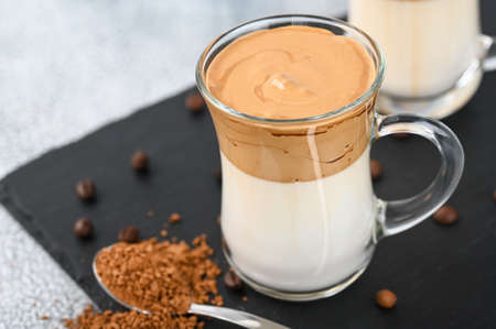 Two glass cups with Dalgona frothy coffee trend korean drink latte espresso with coffee foam on light backgroundの写真素材
