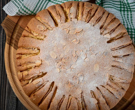 Homemade Organic Apple Pie with almond and cinnamon. Dessert Ready to Eat. Top view on dark wooden backgroundの写真素材