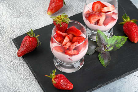 Dessert with fresh strawberry, ricotta, strawberry jam and basil on glasses. High quality photoの写真素材
