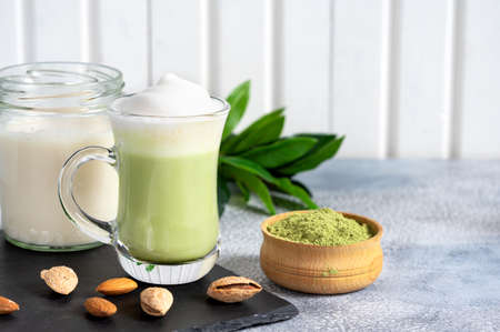 Matcha cappuccino with almond milk cup close-up background blurred.の写真素材