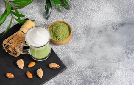 Matcha cappuccino with almond milk cup close-up background blurred.の写真素材