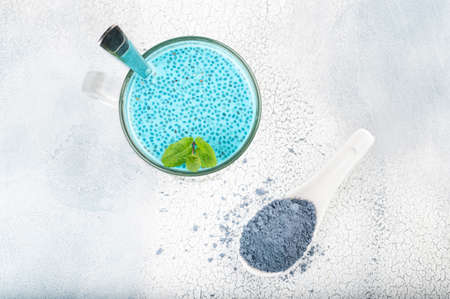 Matcha blue tea chia seed pudding, dessert with fresh mint, coconut milk and blueberry on light background Healthy breakfastの写真素材