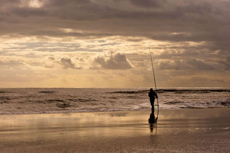 Fishing at sunset の写真素材