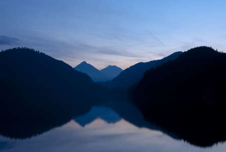 Reflection in the lake Alpsee (Germany)の写真素材