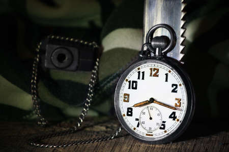Pocket watch with gun and knifeの写真素材