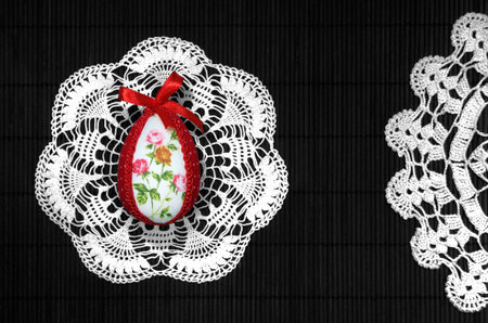 Easter egg on lace and vertical black, bows in background