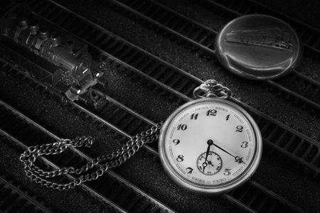 Pocket watch with train, locomotive, cover and chain on rails